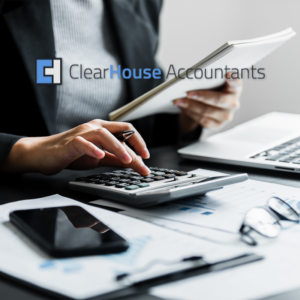 Accountant using calculator with reports and laptop, ClearHouse Accountants logo overlay