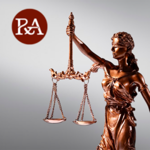 Bronze Lady Justice statue holds chain scales while blindfolded, with a P&A law logo on a gray background