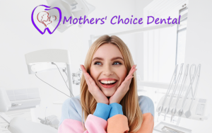 Smiling young woman in pastel sweater at bright dental clinic, with Mothers' Choice Dental logo above her